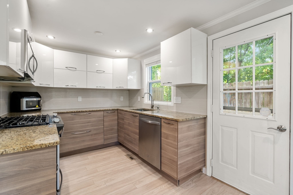 149 Bolivar Street, Unit C6 Canton, MA 02021 - Photo 8 of 41 a kitchen with stainless steel appliances granite countertop a stove and a sink
