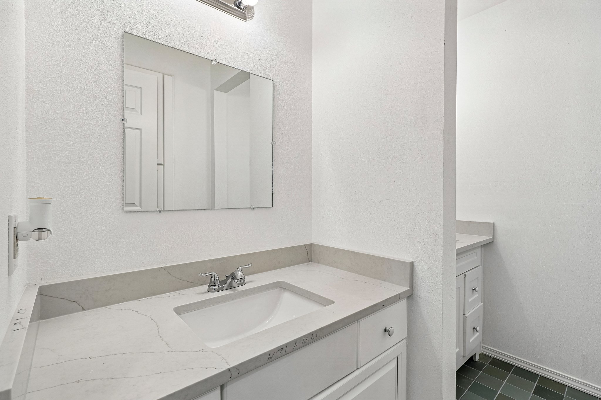 5809 Coventry Lane Austin, TX 78723 - Photo 21 of 35 Upstairs bathroom with a modern double vanity with a sleek countertop and polished faucet adds a touch of sophistication to this space.