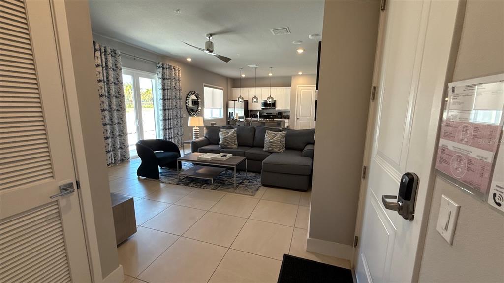 7740 Sandy Ridge Drive, Unit 120 Reunion, FL 34747 - Photo 2 of 36 a living room with furniture and a large window