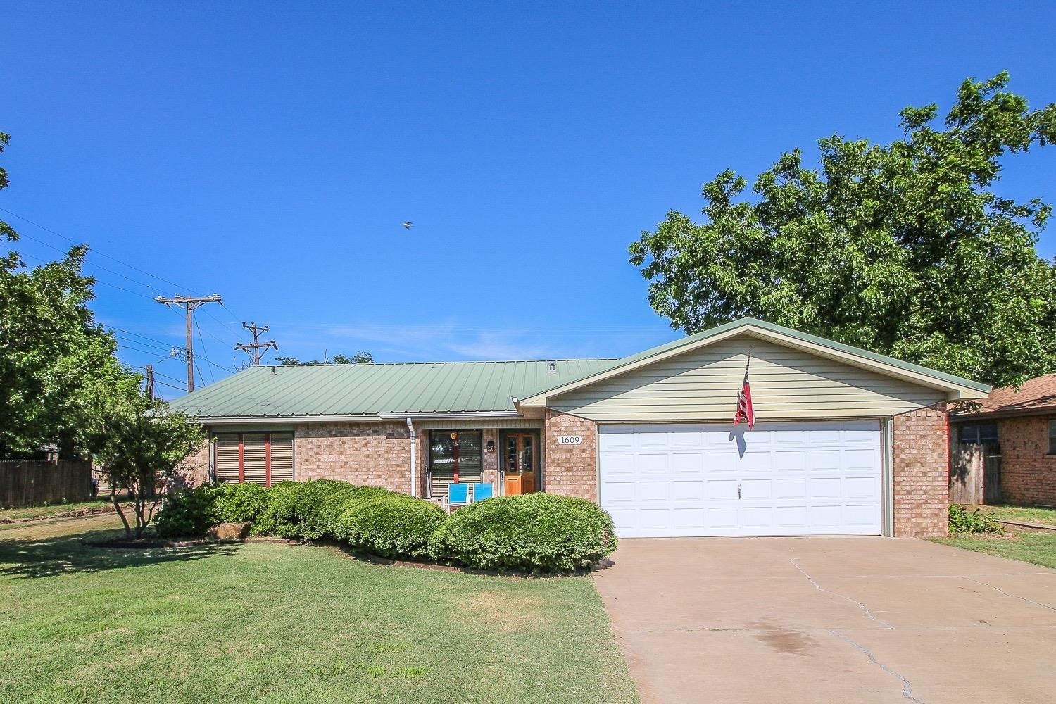 1609 Ave I Ralls, TX 79357 - Photo 1 of 32 a front view of a house with a yard and garage