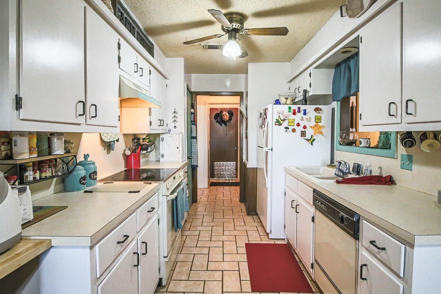 1609 Ave I Ralls, TX 79357 - Photo 11 of 32 a kitchen with a sink stove and cabinets