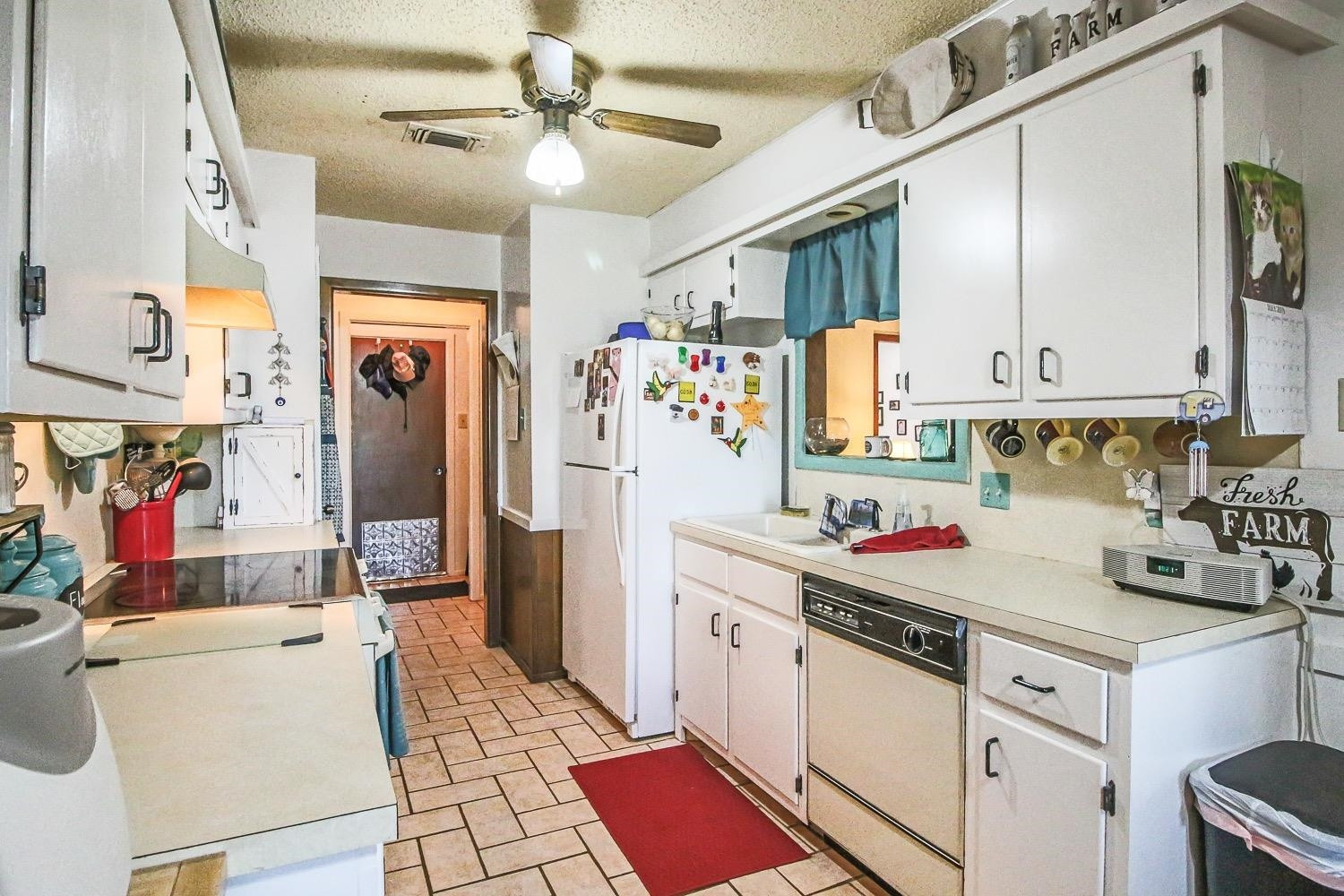 1609 Ave I Ralls, TX 79357 - Photo 12 of 32 a kitchen that has a lot of cabinets a sink and a stove