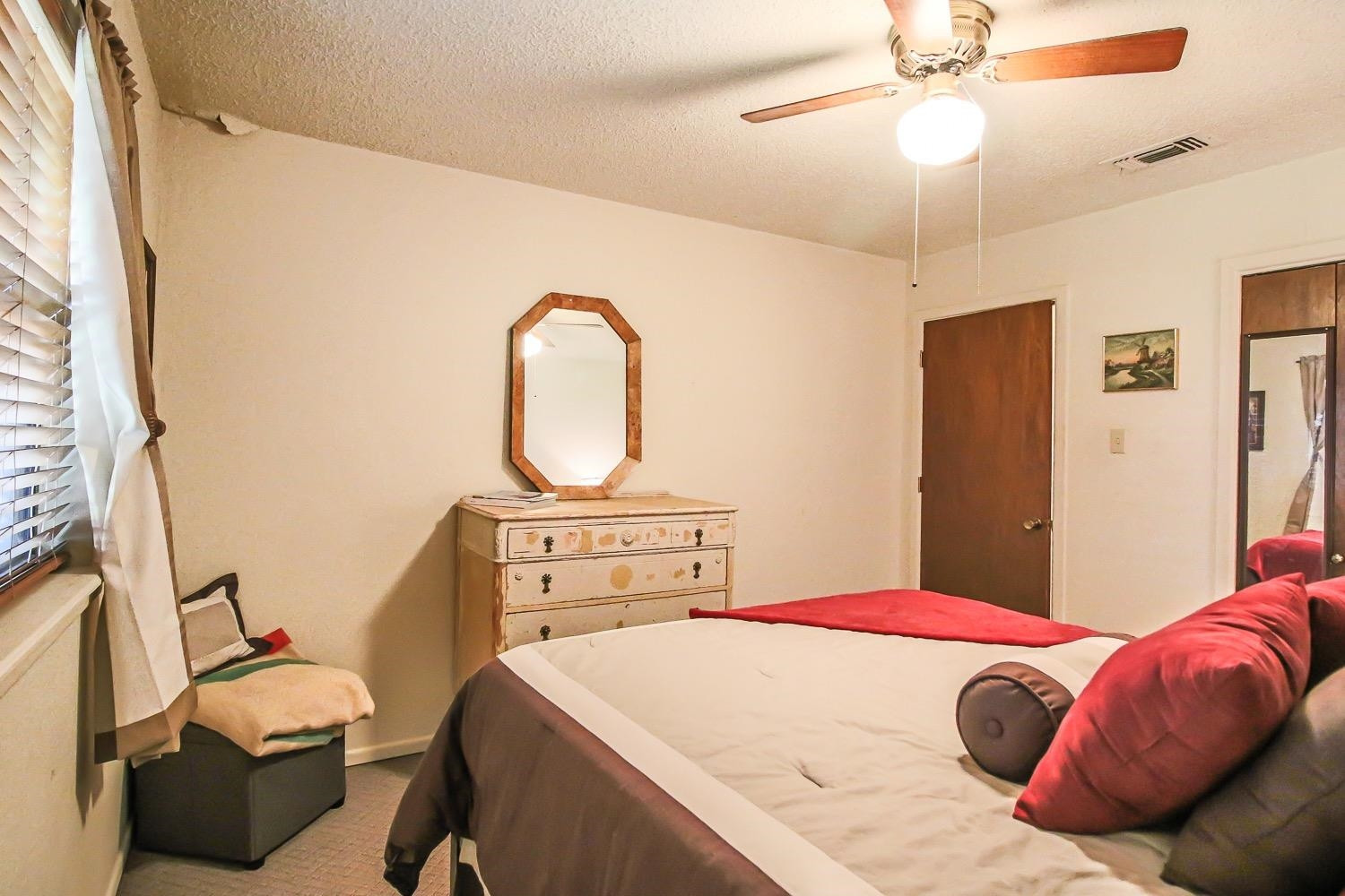 1609 Ave I Ralls, TX 79357 - Photo 21 of 32 a bedroom with a bed and a chandelier