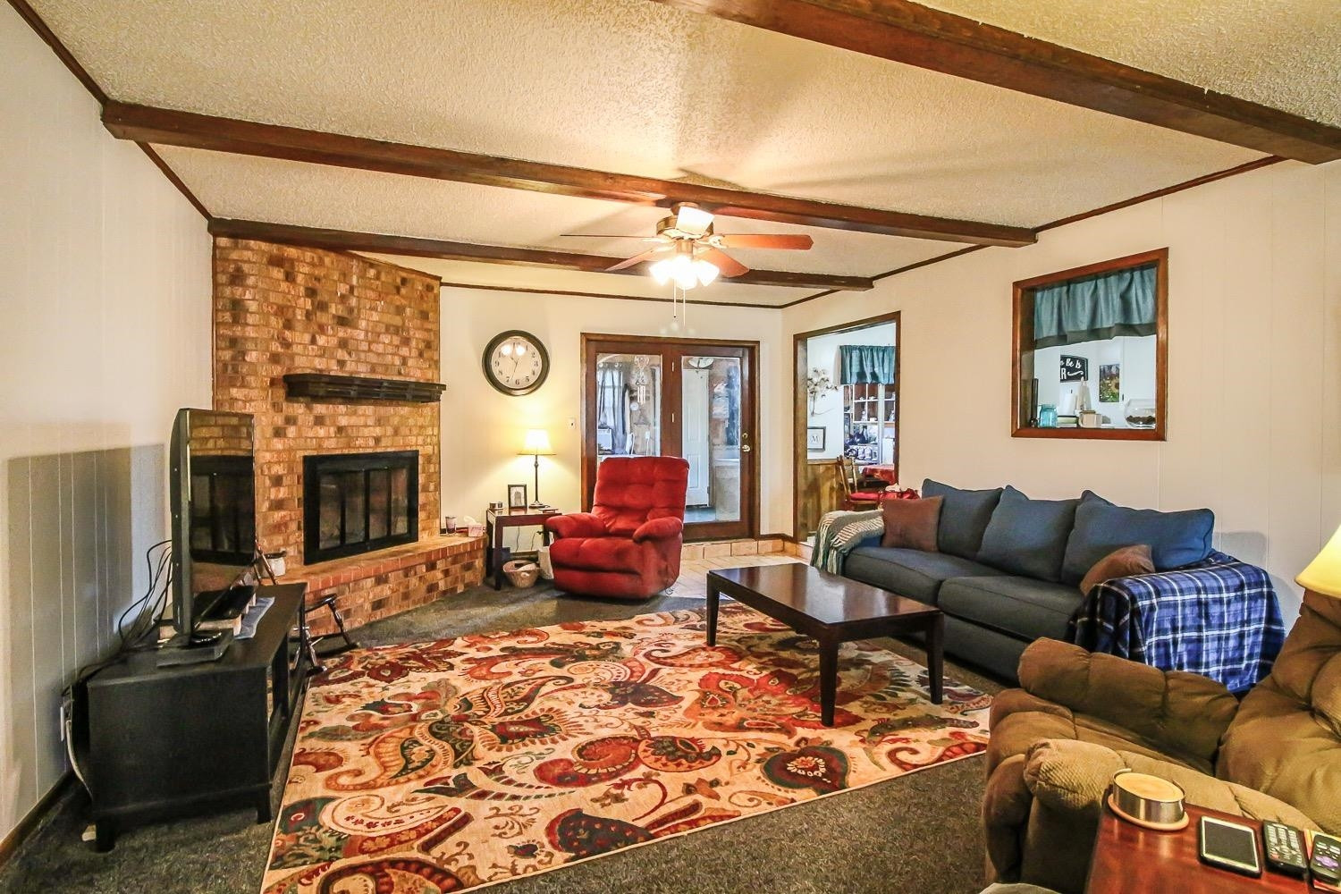 1609 Ave I Ralls, TX 79357 - Photo 7 of 32 a living room with furniture a fireplace and a flat screen tv