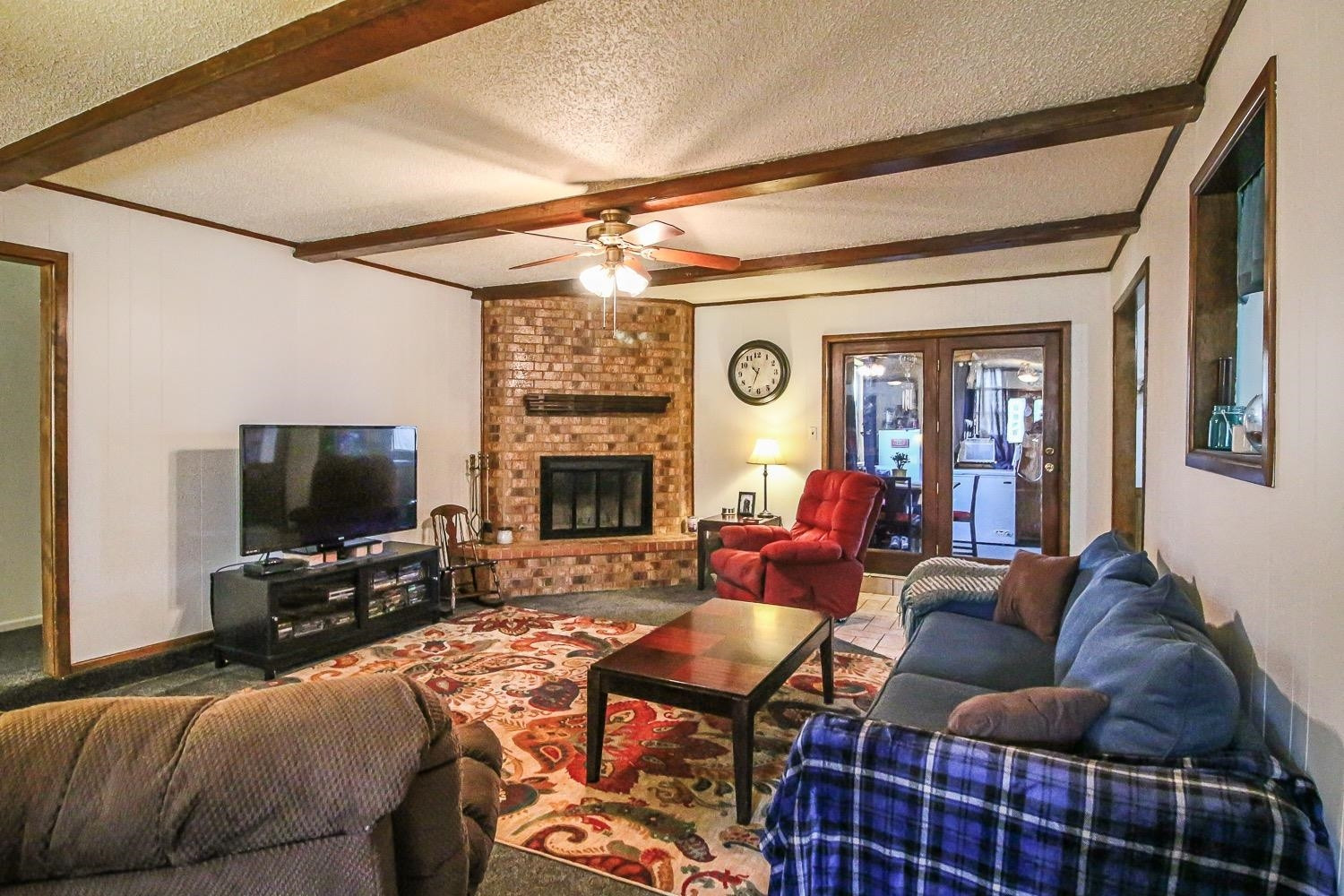 1609 Ave I Ralls, TX 79357 - Photo 8 of 32 a living room with furniture a flat screen tv and a fireplace