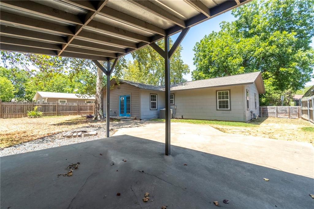 2105 Fortview Road Austin, TX 78704 - Photo 33 of 37 A spacious backyard awaits, complete with a covered patio perfect for outdoor enjoyment and a detached structure offering additional utility.