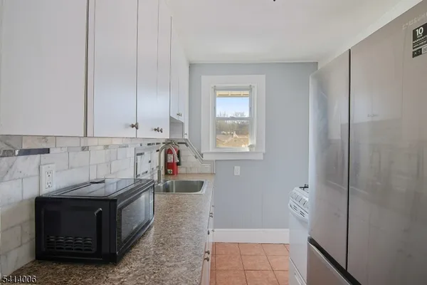 a kitchen with stainless steel appliances granite countertop a refrigerator and a stove