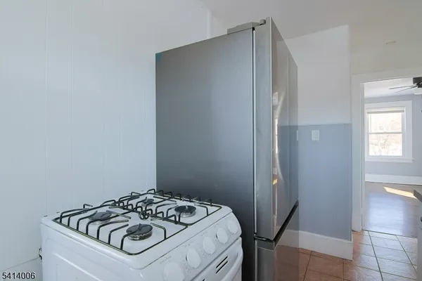 a kitchen with a refrigerator and a stove