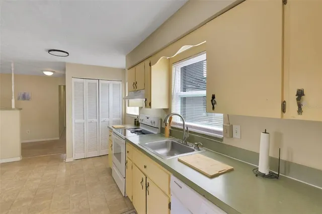 a kitchen with a sink and a refrigerator