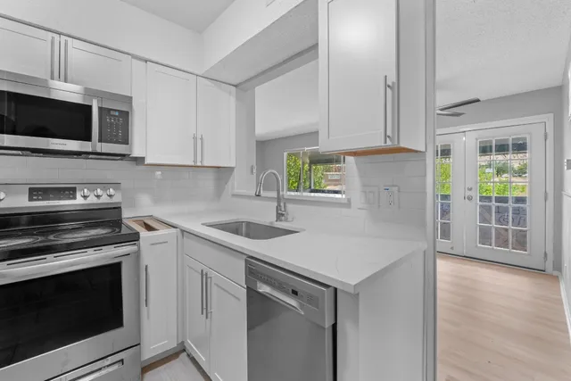 a kitchen with a stove microwave and sink