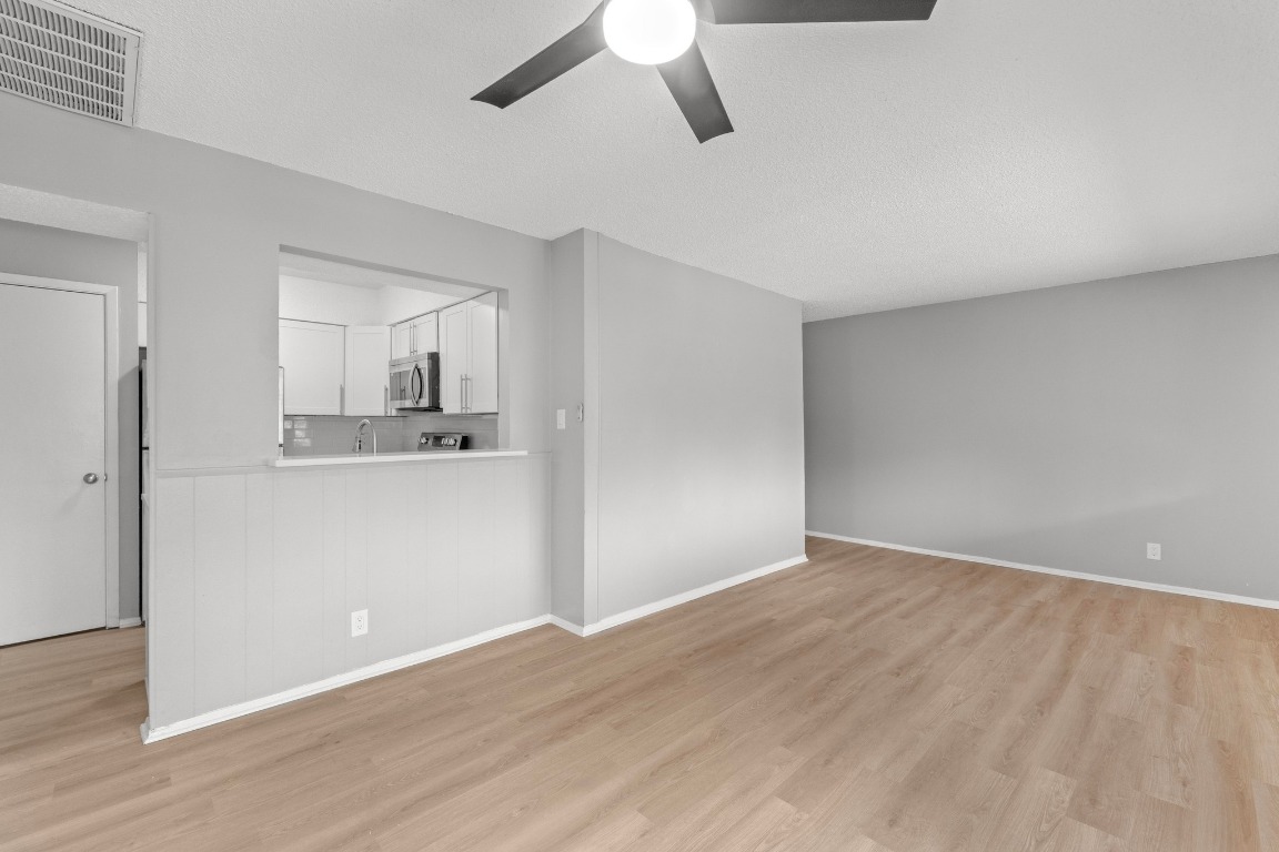 8903 Parkfield Drive, Unit 203 Austin, TX 78758 - Photo 4 of 11 wooden floor in an empty room with a window