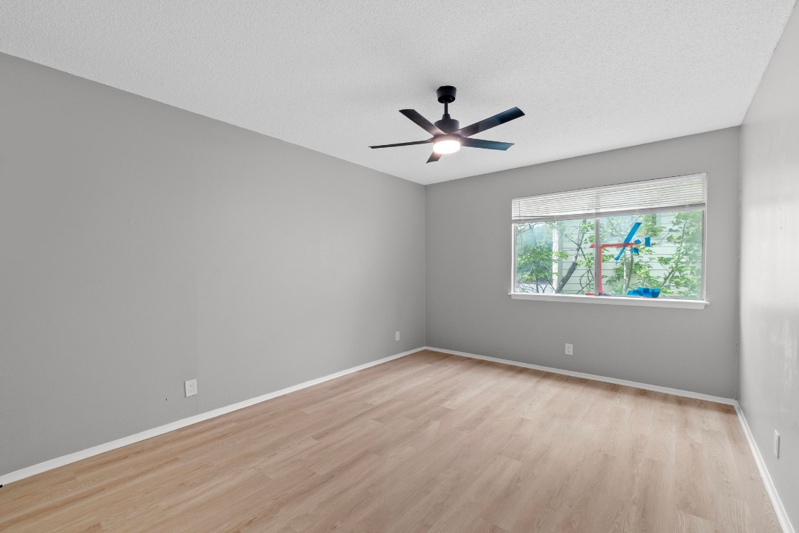 8903 Parkfield Drive, Unit 203 Austin, TX 78758 - Photo 6 of 11 an empty room with a window and a fan