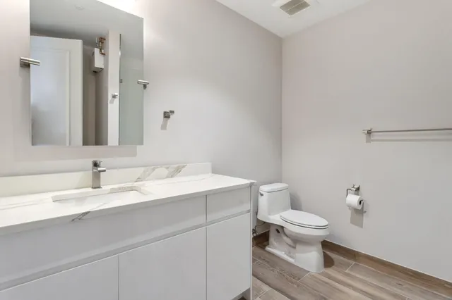 a view of a hallway with closet and wooden floor