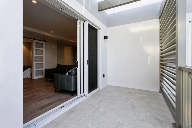 a view of a balcony with wooden floor and iron stairs
