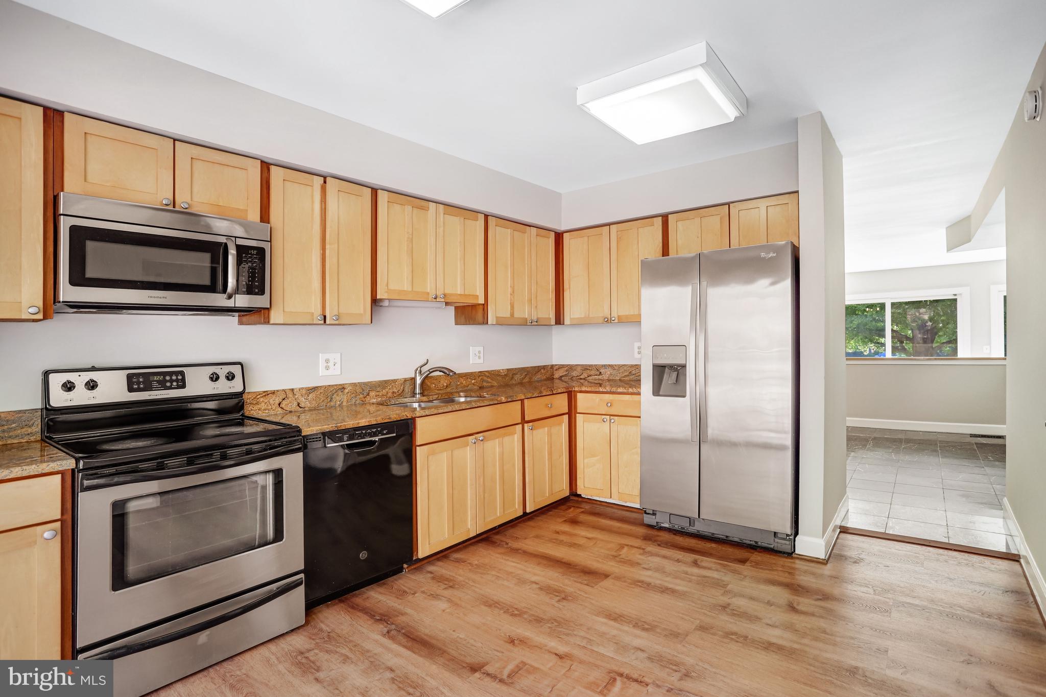 1953 Lakeport Way Reston, VA 20191 - Photo 3 of 60 a kitchen with granite countertop a refrigerator stove and microwave