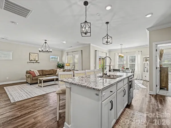 a kitchen with stainless steel appliances granite countertop a stove and a wooden floor