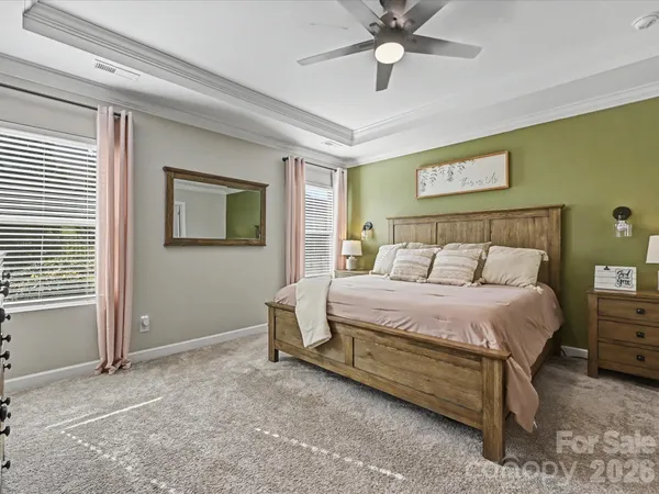 a bedroom with a bed and a chandelier