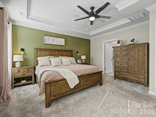 a bedroom with a bed and a tv