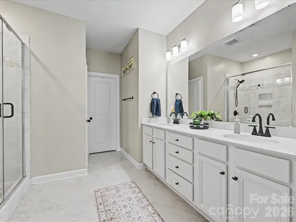 a spacious bathroom with double sink and a mirror