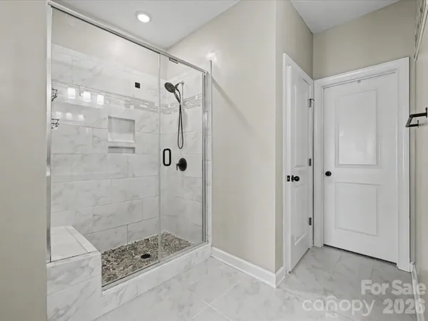 a bathroom with a shower and a sink