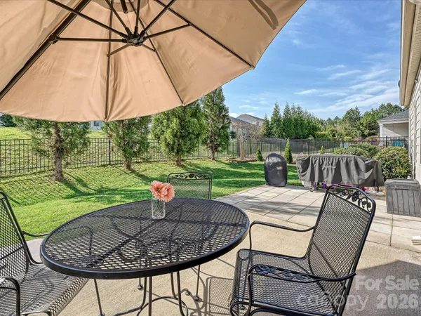 a patio with a yard table and chairs