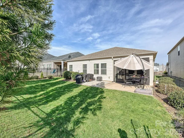 a view of house with backyard and patio