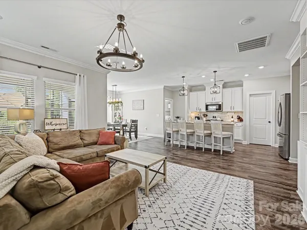 a living room with furniture and kitchen view