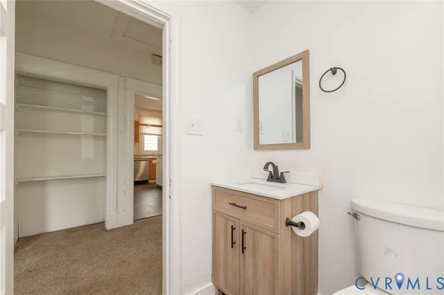 a bathroom with a sink toilet and mirror