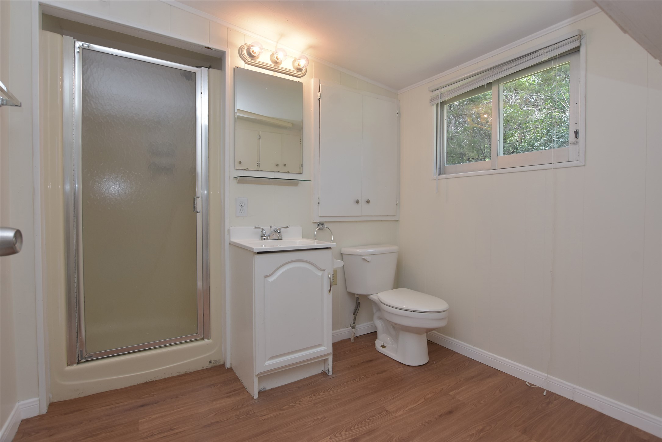 16013 Edwards Drive Austin, TX 78734 - Photo 19 of 30 Bathroom featuring vanity, a stall shower, and light wood-style flooring