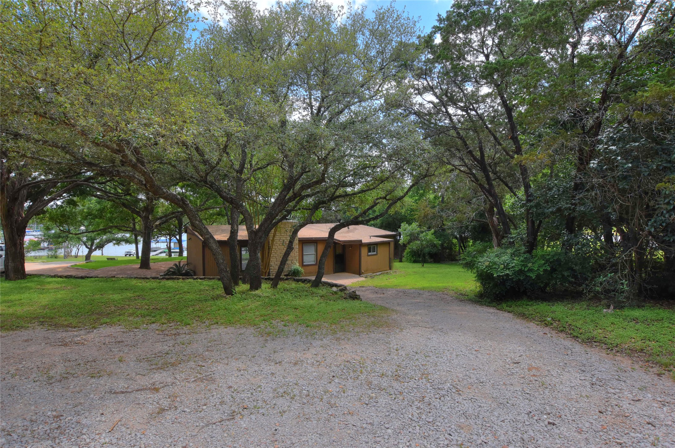 16013 Edwards Drive Austin, TX 78734 - Photo 2 of 30 View of front of property with gravel driveway and a front lawn