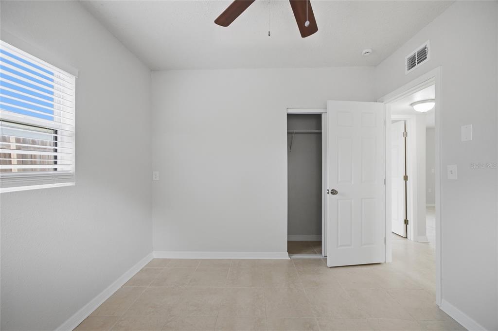 6629 Sierra Terrace New Port Richey, FL 34652 - Photo 17 of 30 an empty room with ceiling fan and window