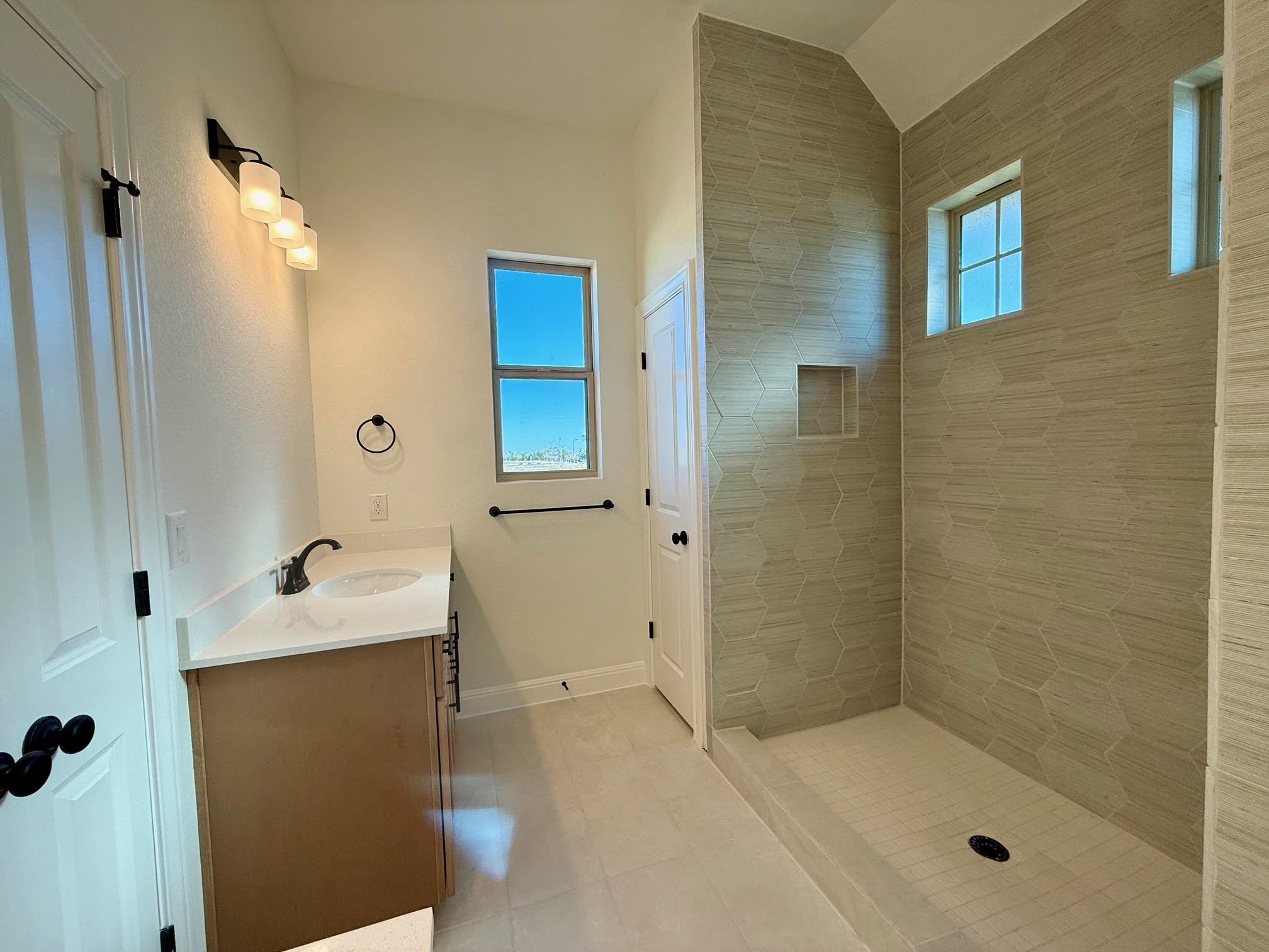 332 Glocken Lane Kyle, TX 78640 - Photo 14 of 27 a bathroom with a shower sink and mirror