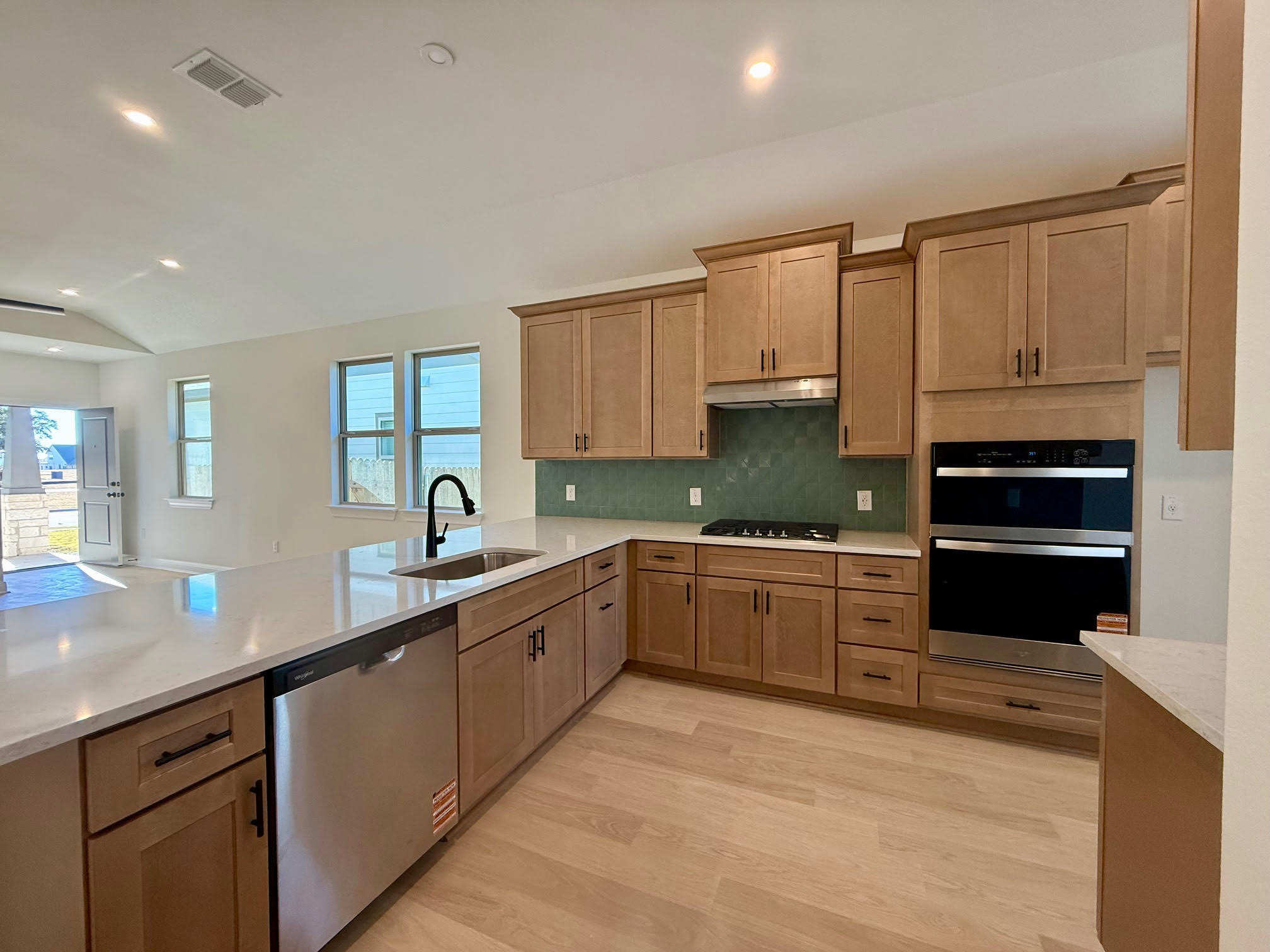 332 Glocken Lane Kyle, TX 78640 - Photo 8 of 27 a kitchen with granite countertop a sink stainless steel appliances and cabinets