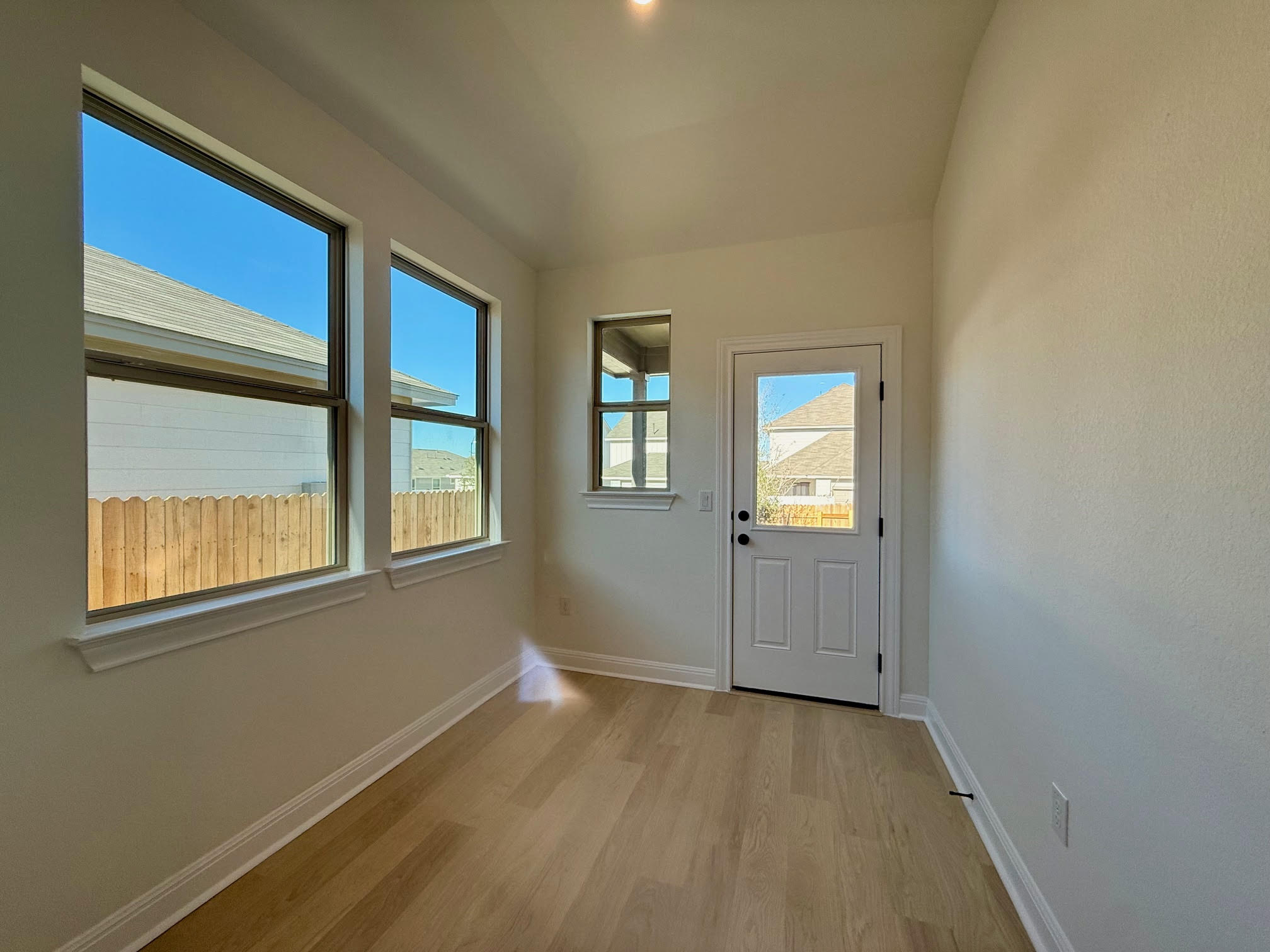 332 Glocken Lane Kyle, TX 78640 - Photo 10 of 27 a view of an empty room with wooden floor and a window