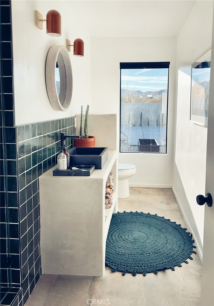 1212 Acoma Trail Landers, CA 92285 - Photo 13 of 23 a bathroom with a tub and a shower