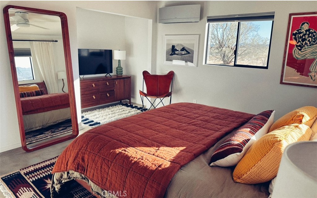 1212 Acoma Trail Landers, CA 92285 - Photo 14 of 23 a bedroom with a bed and wooden floor