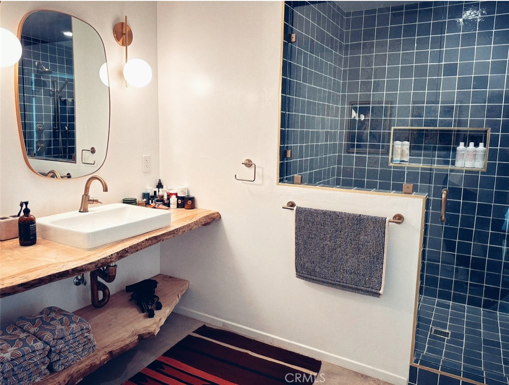 1212 Acoma Trail Landers, CA 92285 - Photo 15 of 23 a bathroom with a sink mirror and vanity