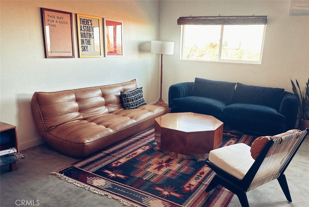 1212 Acoma Trail Landers, CA 92285 - Photo 21 of 23 a living room with furniture a rug and a window