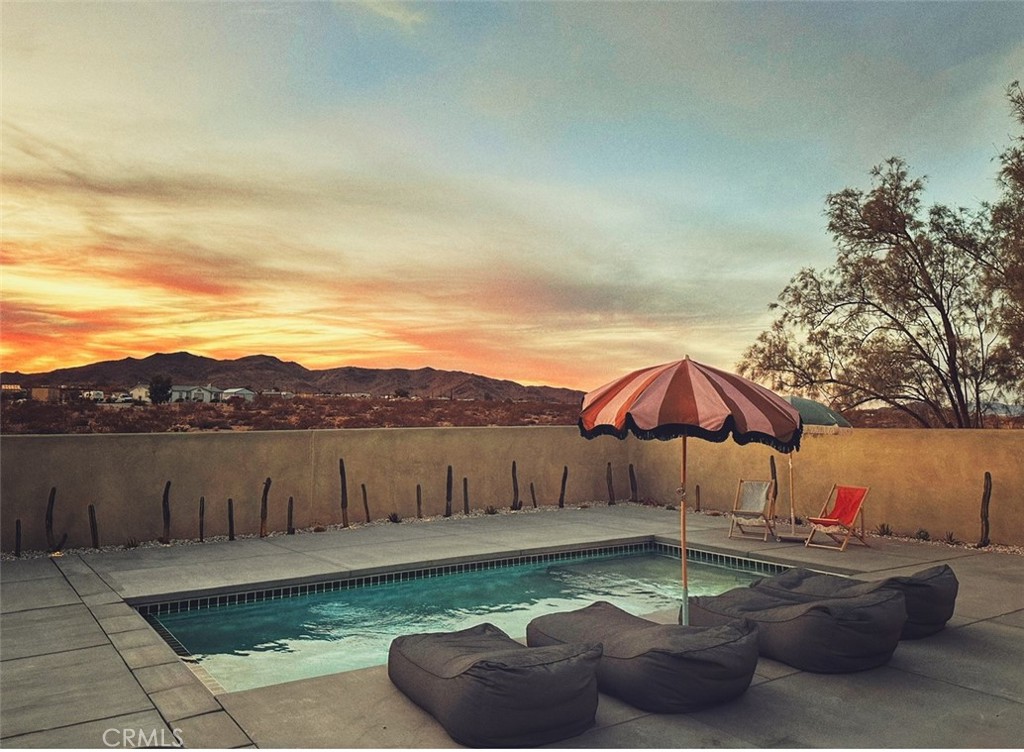 1212 Acoma Trail Landers, CA 92285 - Photo 23 of 23 a view of a lake with a table and chairs under an umbrella