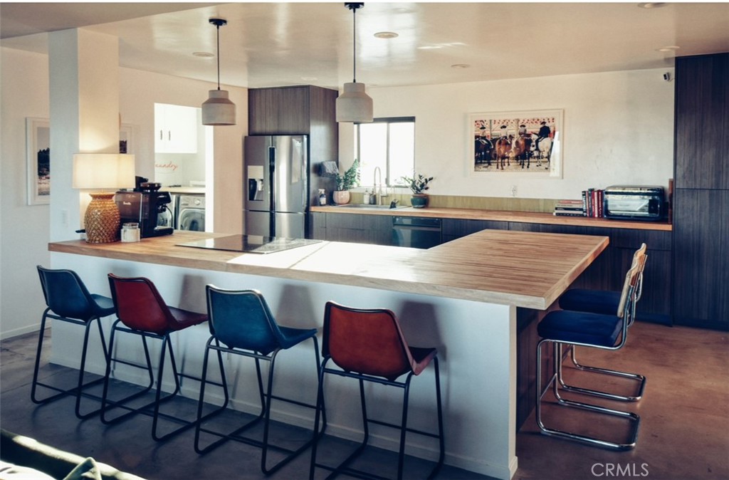 1212 Acoma Trail Landers, CA 92285 - Photo 6 of 23 a dining hall with a dining table and chairs with wooden floor
