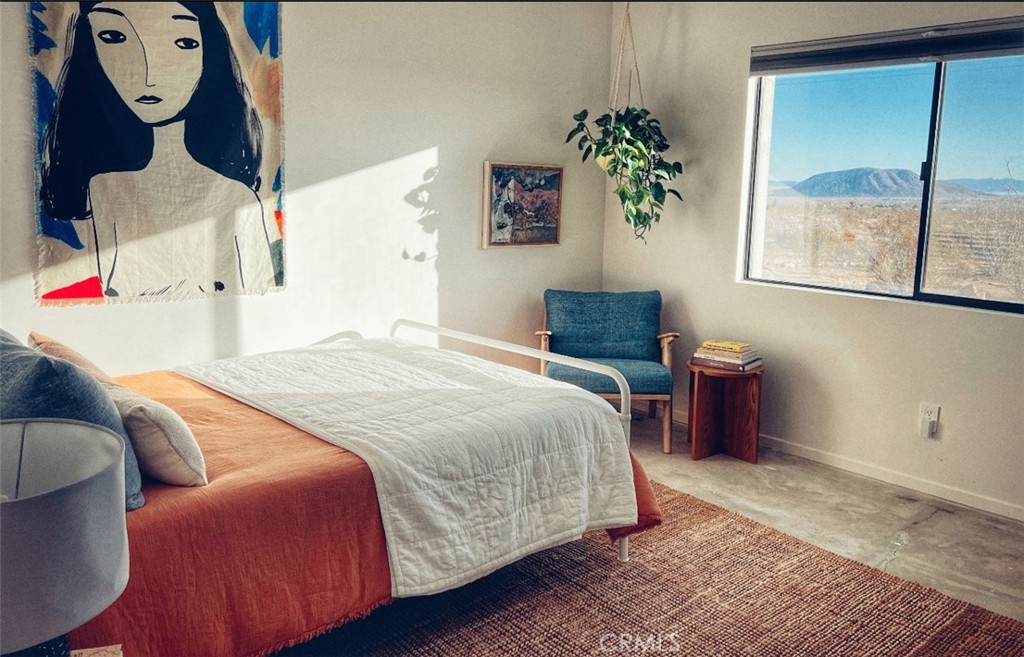 1212 Acoma Trail Landers, CA 92285 - Photo 10 of 23 a bedroom with a bed and a window