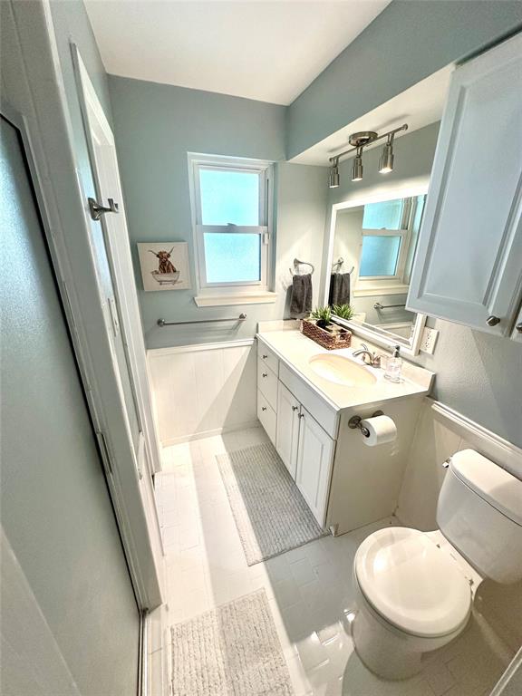 8415 Hunnicut Road Dallas, TX 75228 - Photo 13 of 17 a bathroom with a toilet sink and mirror