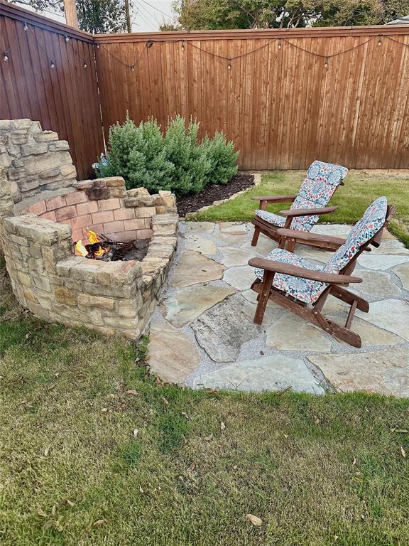 8415 Hunnicut Road Dallas, TX 75228 - Photo 16 of 17 a view of a backyard with plants and a patio