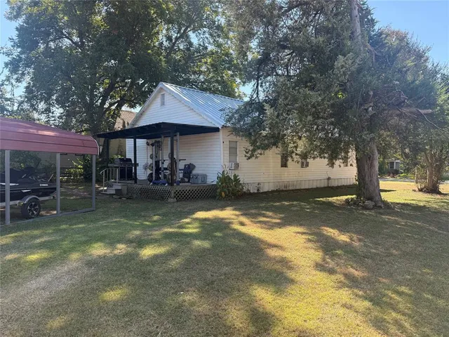 a view of a house with swimming pool and sitting area