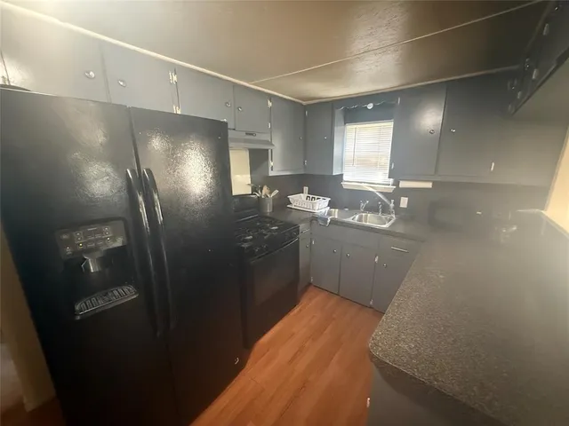 a kitchen with refrigerator and window