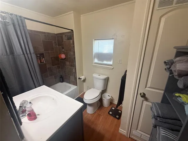 a white toilet sitting next to a bathroom sink