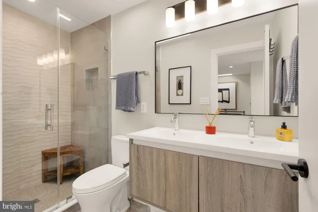 a bathroom with a toilet sink and shower