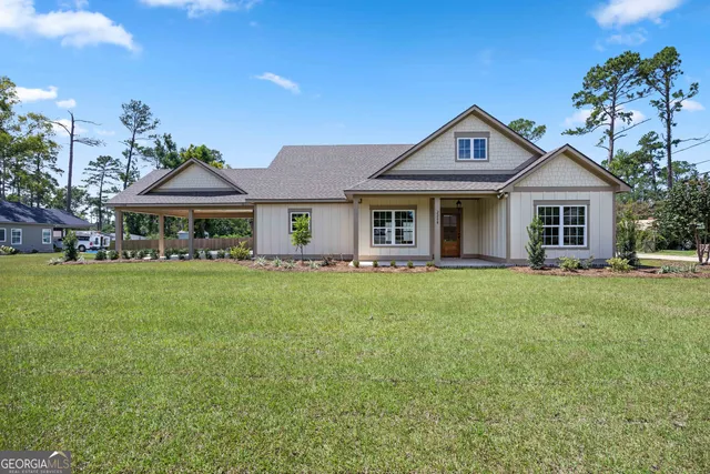 a front view of a house with a garden