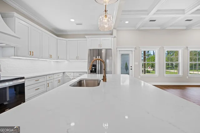 a kitchen with kitchen island granite countertop a sink and a stove