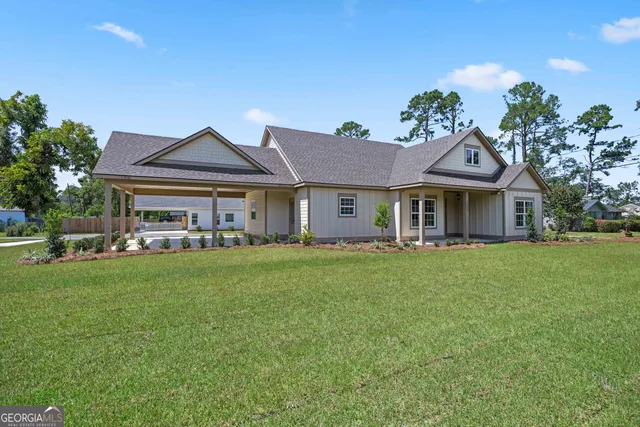 a front view of a house with a garden